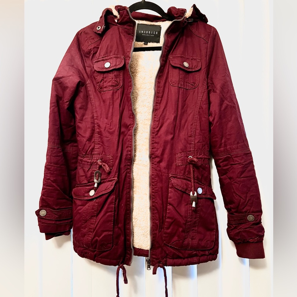 Burgundy women’s winter coat with detachable hood and adjustable waist.